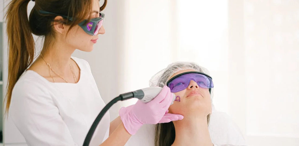 Aesthetic professional performing a non-surgical procedure on a client using advanced technology.